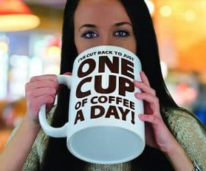 Woman drinking a very large cup of coffee